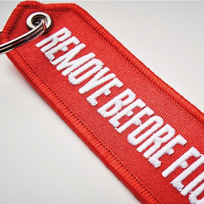 Embroidered key tag with triangular shaped end - Embroidered key tag with triangular shaped end